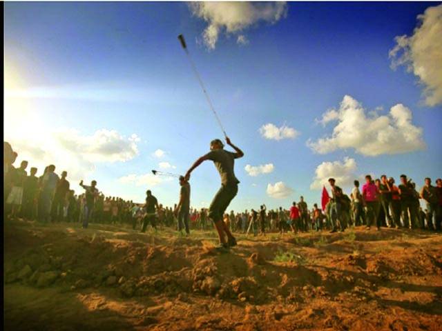 غزہ سٹی: فلسطینی مظاہرین غلیل کے ذریعے اسرائیلی فوجیوں پر پتھر پھینک رہے ہیں